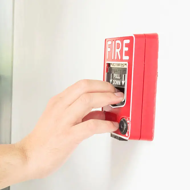a person hand switching off the fire alarm
