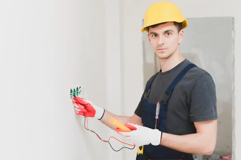 a electrician standing along with switch board